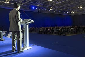 Rear view of Jason Kim on stage with the audience watching