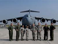 Air Force personnel in front of a cargo aircraft