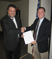 Michael Bosco and Kenneth Hodgkins shake hands at the conclusion of the meeting
