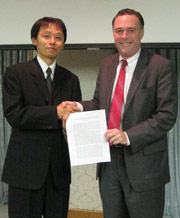 Jun Yanagi and Kenneth Hodgkins shake hands at the conclusion of the meeting