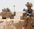 soldier in front of military vehicle