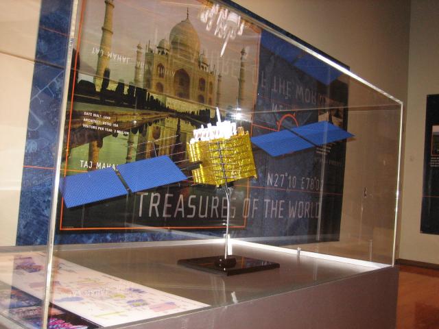 GPS satellite model in a glass enclosure.